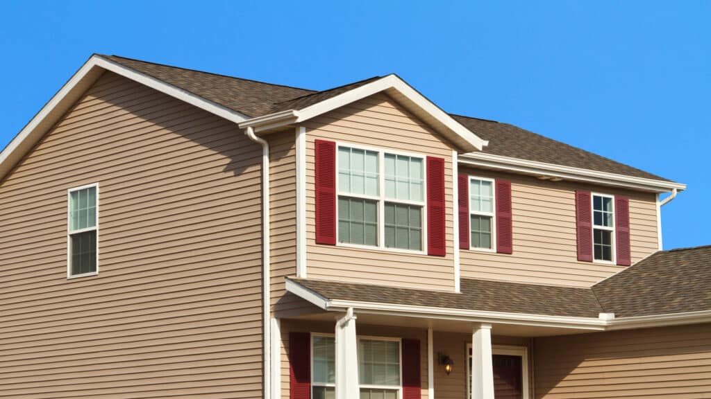 a standard looking brown house with a fresh, new roof
