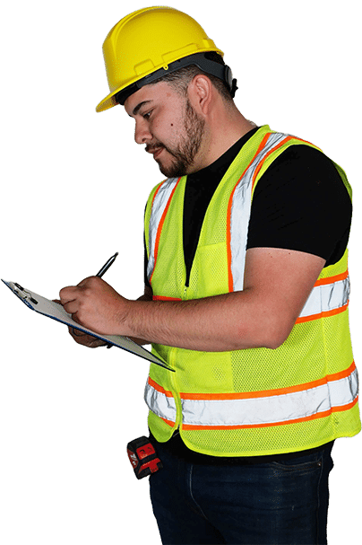 man in a hardhat and a high visibility vest writing on a clipboard