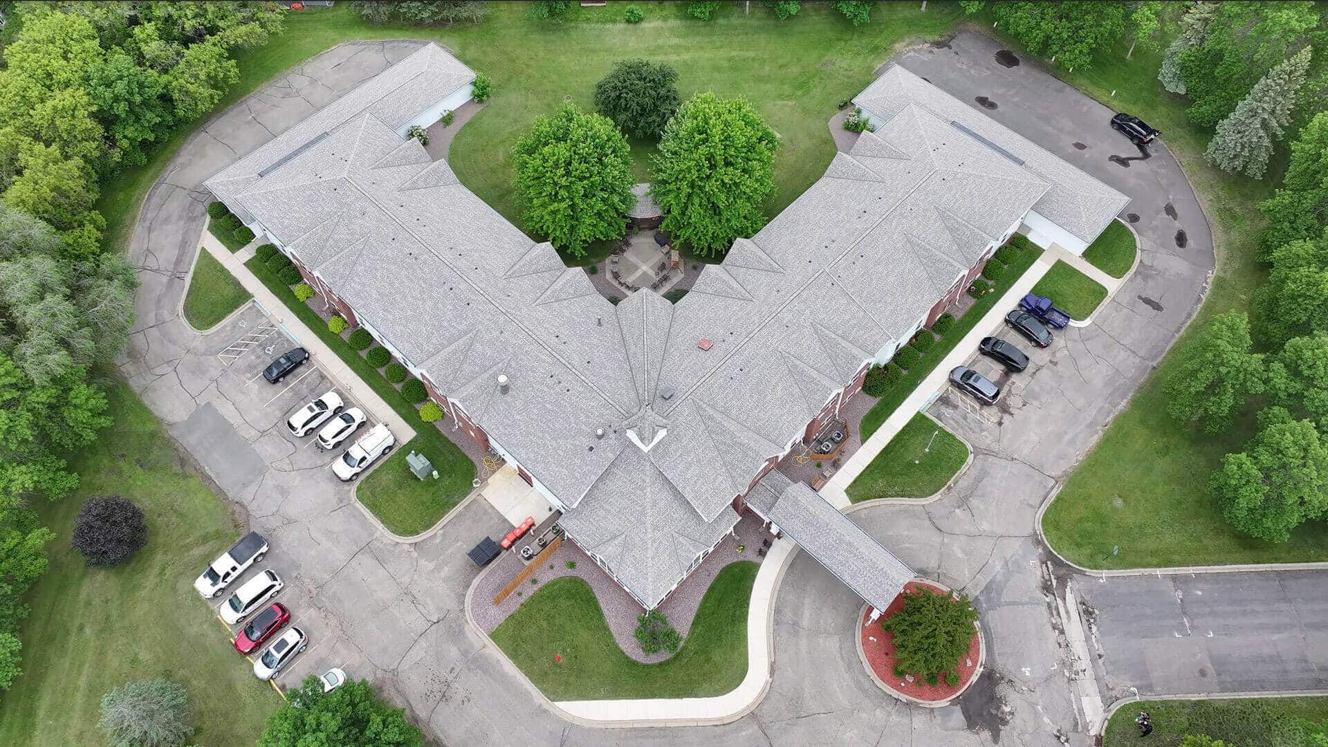 an overhead view of an apartment complex with a beautiful roof